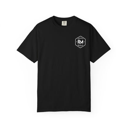 Front of a black Roadie Merch logo T-shirt with a small white RM badge on the left chest.