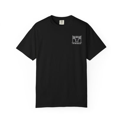 Front of a black Cotton Dealer T-shirt with a white garment rack and hanging shirt graphic on the left chest.