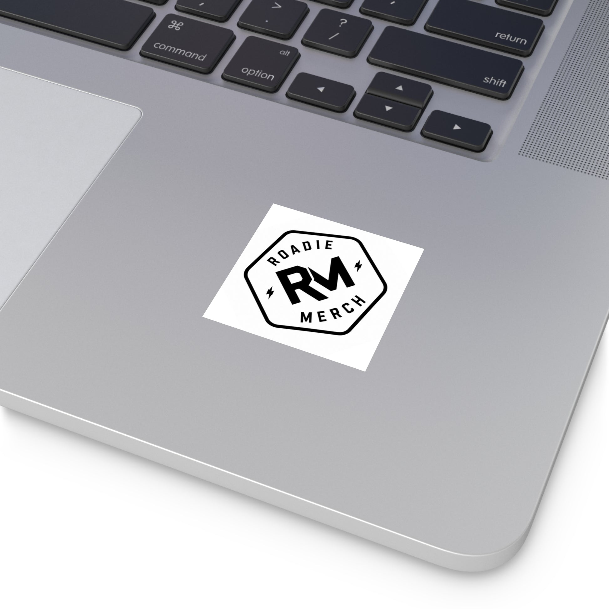 Roadie Merch logo vinyl sticker applied to the silver surface of a laptop.