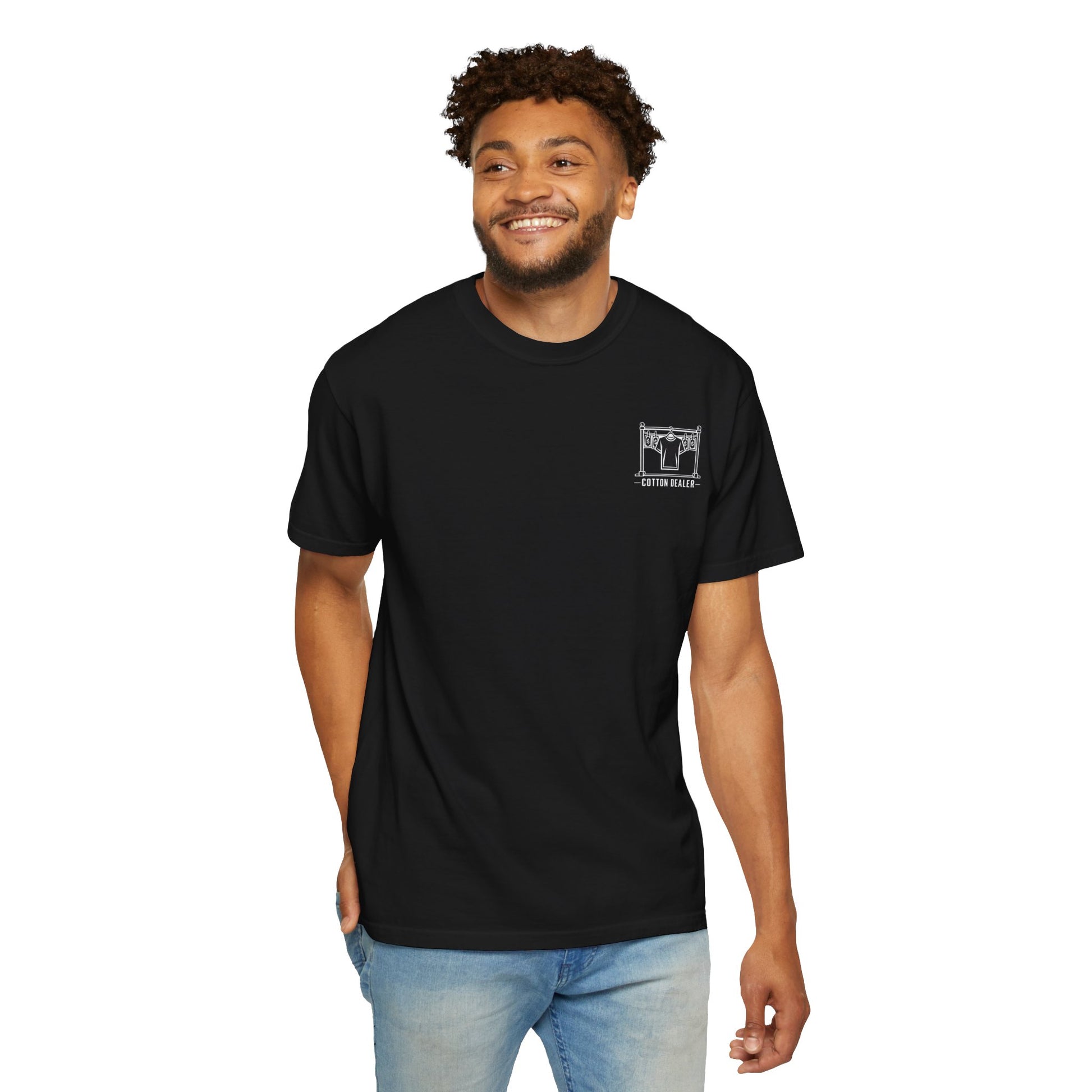 Model wearing the black Cotton Dealer merch crew T-shirt with a white chest graphic.