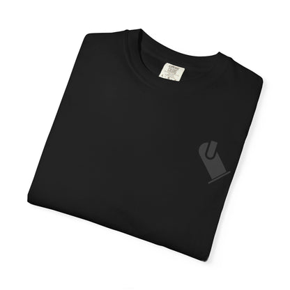 Folded black OG LX T-shirt showing the subtle lighting-department chest graphic.