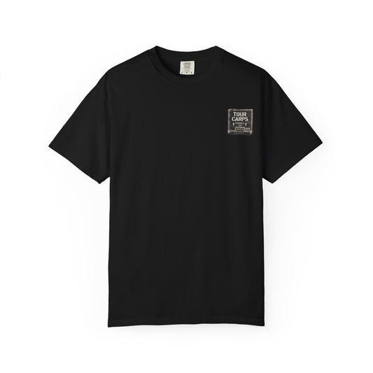 Front of a black Tour Carps T-shirt with a distressed road-case label graphic on the left chest.